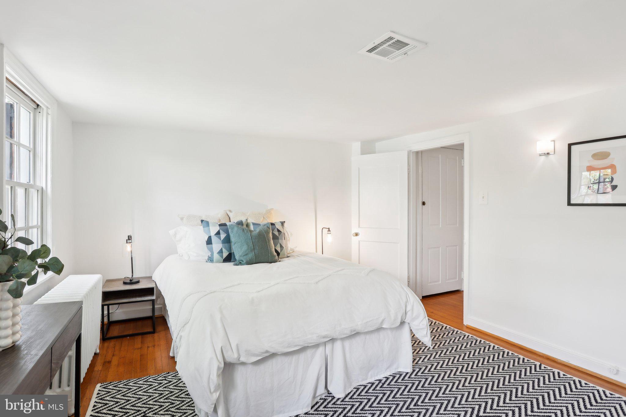 321 South Smedley Street Philadelphia, PA 19103 - Photo 31 of 39 a bedroom with a bed and a table