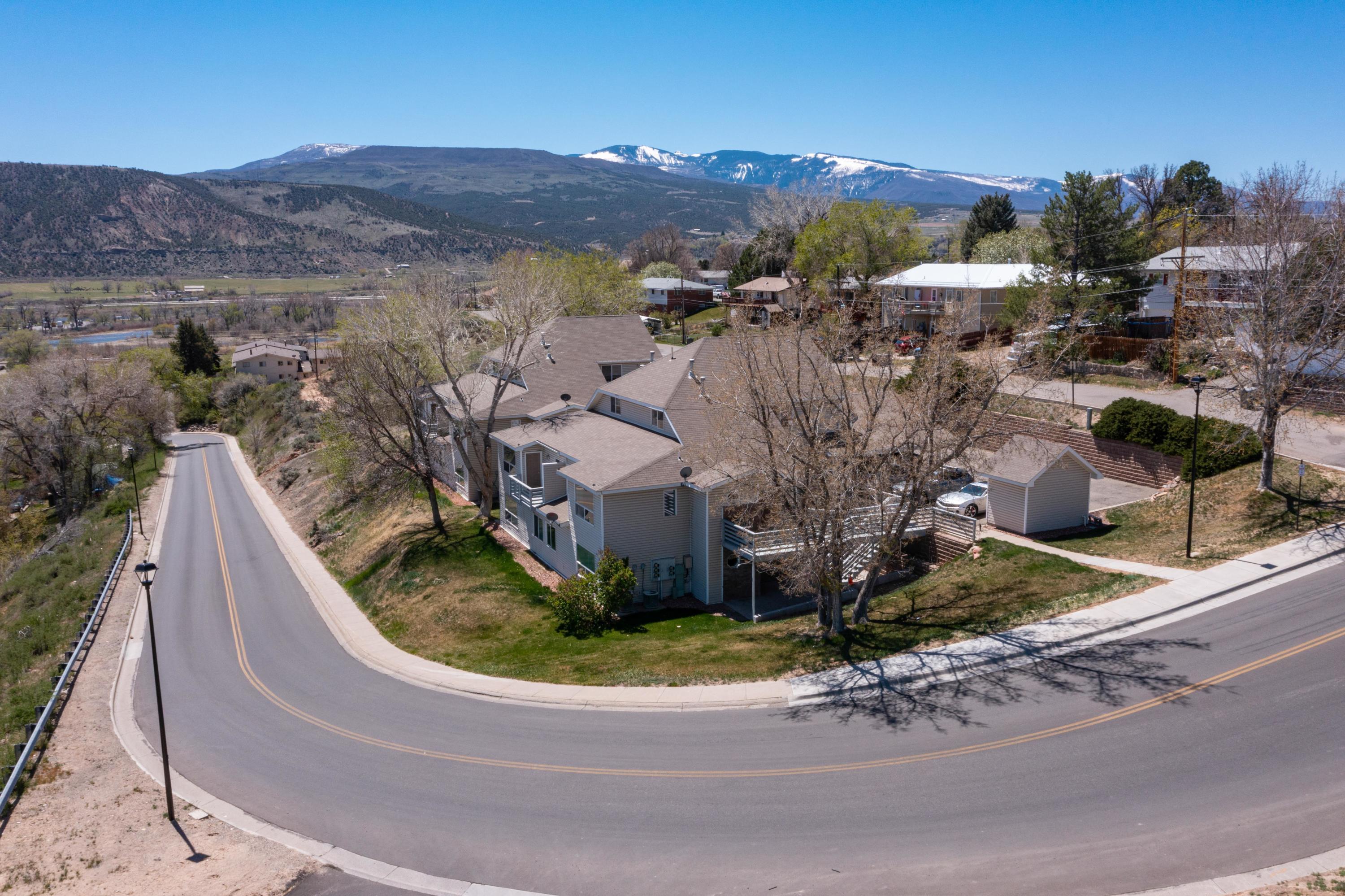 444 Lind Avenue Rifle, CO 81650 - Photo 12 of 13 a view of a house with a mountain and a yard