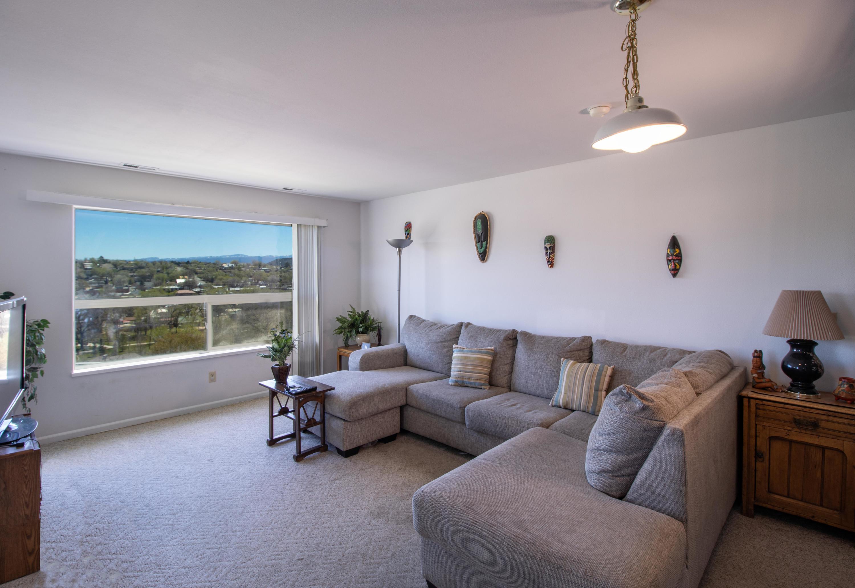 444 Lind Avenue Rifle, CO 81650 - Photo 3 of 13 a living room with furniture and large windows