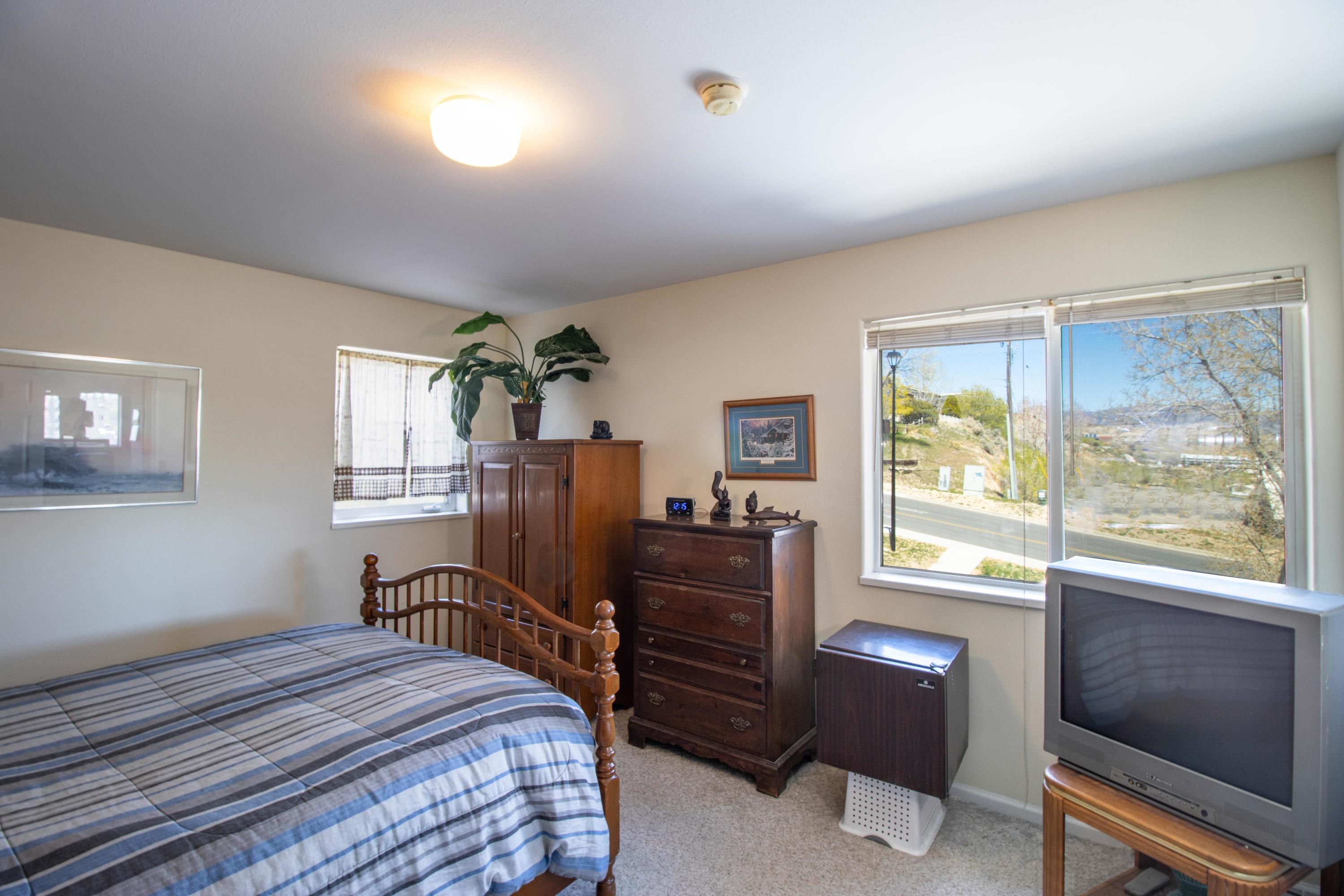 444 Lind Avenue Rifle, CO 81650 - Photo 5 of 13 a bedroom with a bed and wooden floor