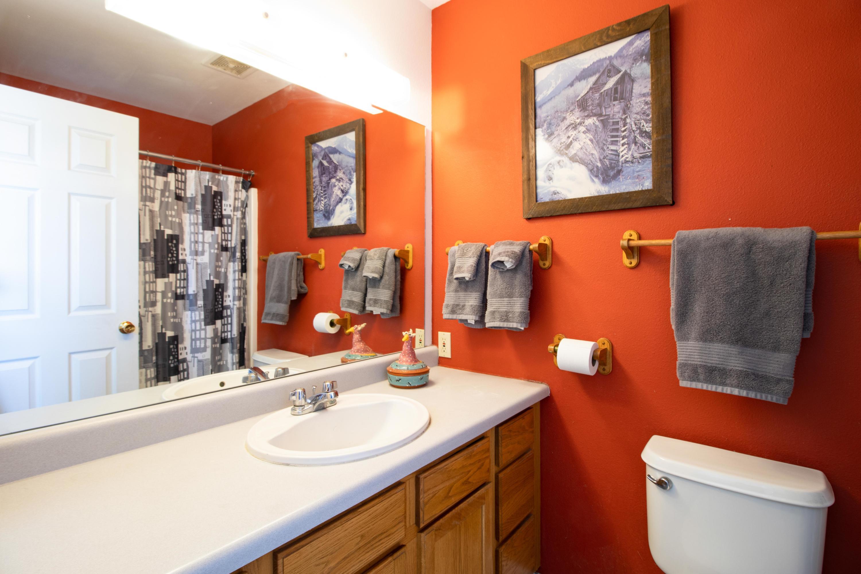 444 Lind Avenue Rifle, CO 81650 - Photo 6 of 13 a bathroom with a toilet sink and mirror