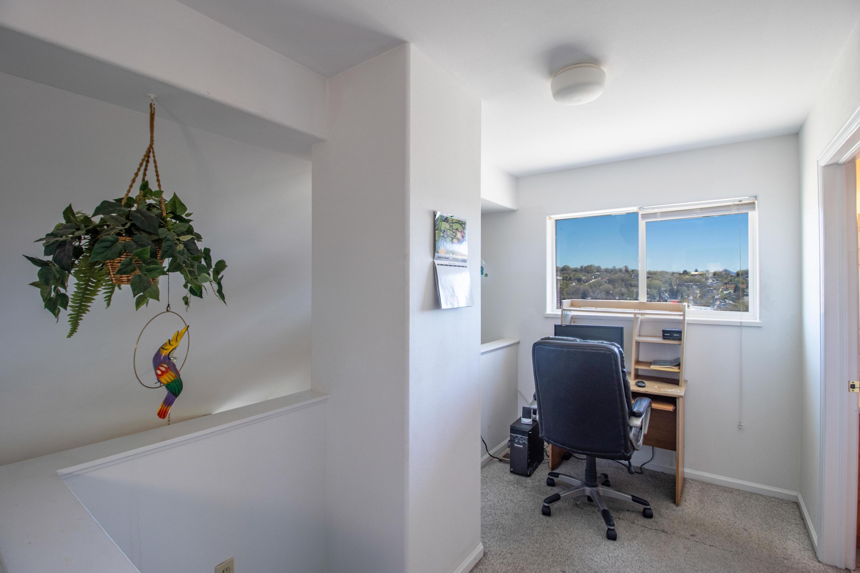 444 Lind Avenue Rifle, CO 81650 - Photo 7 of 13 a view of a workspace with furniture and a window