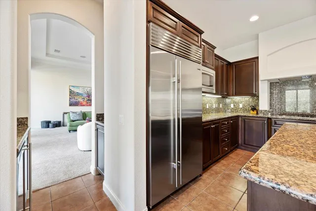 a kitchen with granite countertop stainless steel appliances and wooden cabinets