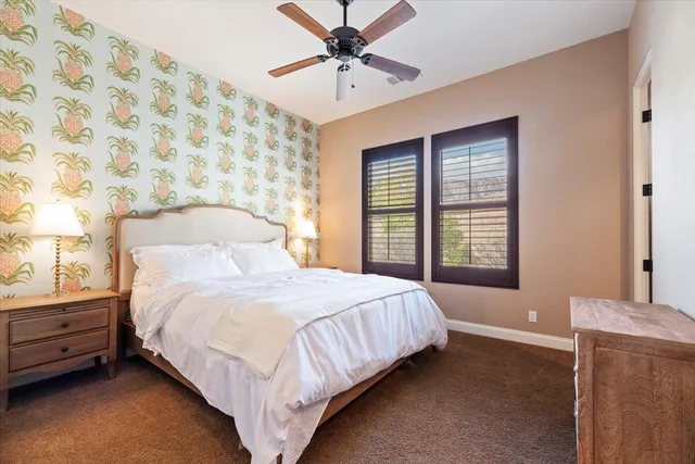 a bathroom with a granite countertop sink toilet and mirror