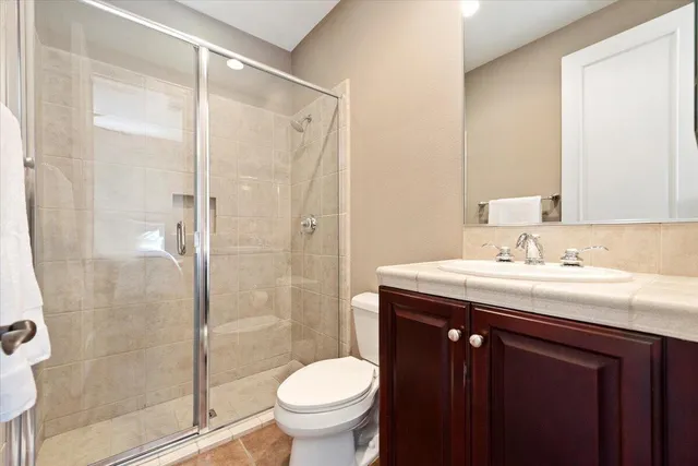 a bedroom with a bed and a ceiling fan