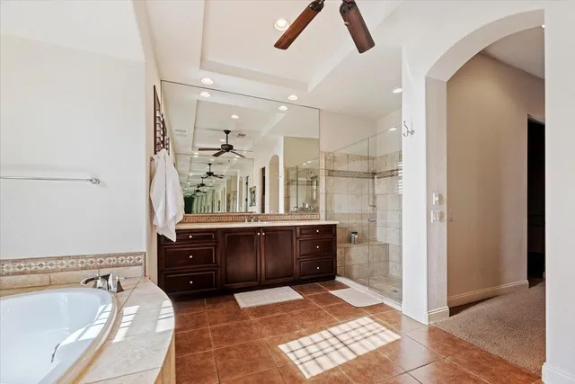 a spacious bedroom with a bed a table and large window