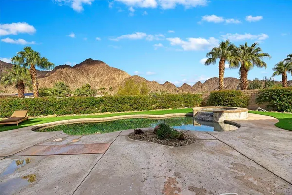 a view of a house with swimming pool and sitting area