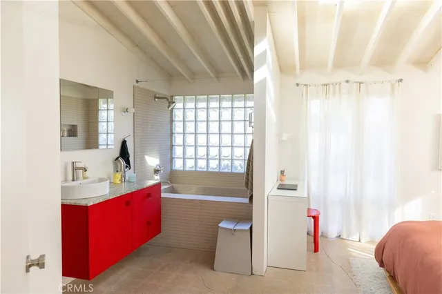 a bedroom with a bed and a window