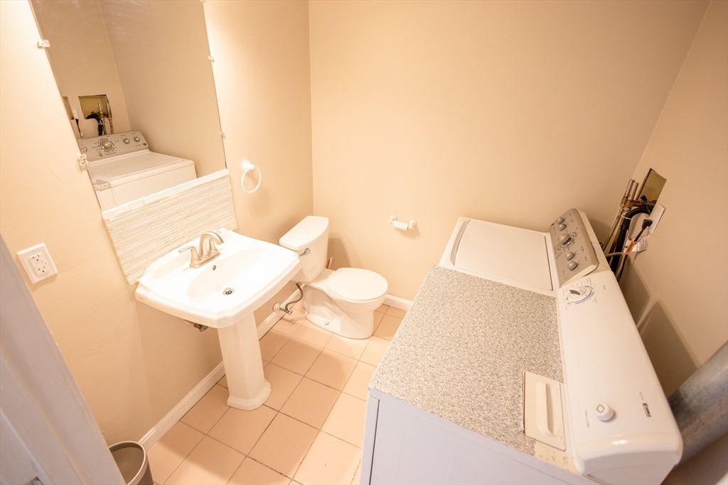 5337 B Washington Street, Unit B Boston, MA 02132 - Photo 11 of 41 a bathroom with a sink and mirror