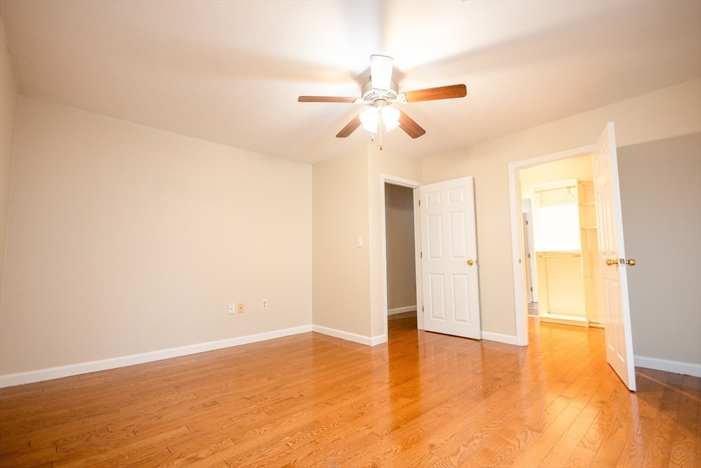 5337 B Washington Street, Unit B Boston, MA 02132 - Photo 23 of 41 a view of a room with wooden floor and ceiling fan