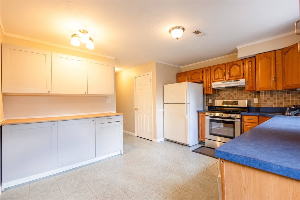 5337 B Washington Street, Unit B Boston, MA 02132 - Photo 3 of 41 a kitchen with refrigerator cabinets and a sink