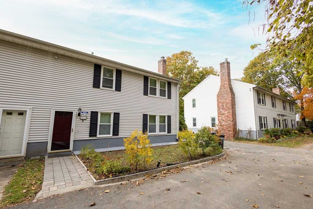 5337 B Washington Street, Unit B Boston, MA 02132 - Photo 36 of 41 a front view of a house with a garden
