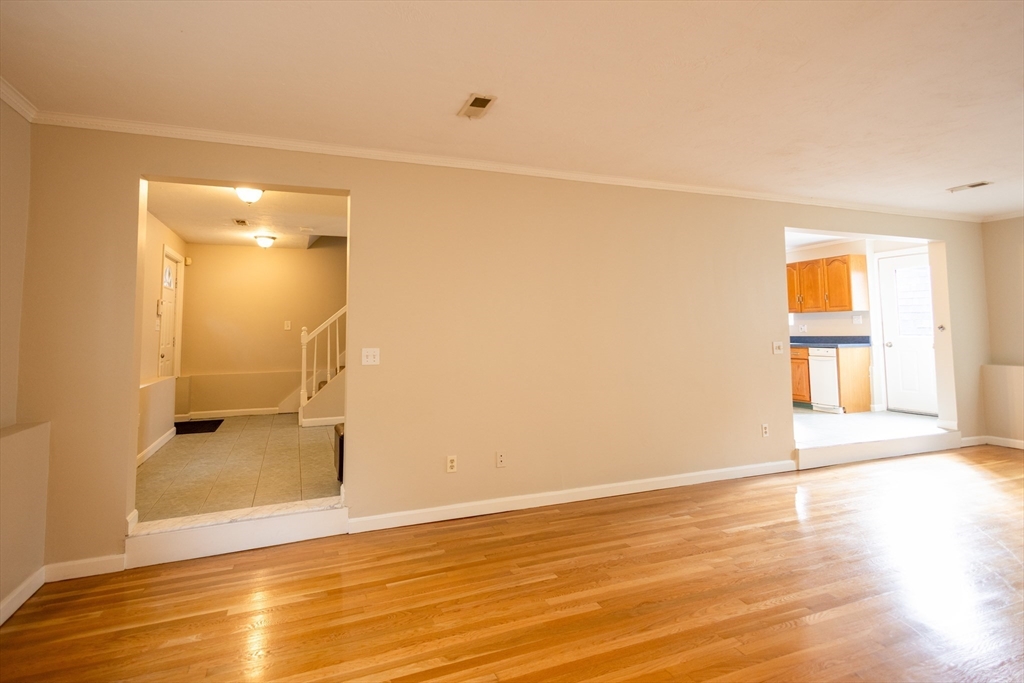 5337 B Washington Street, Unit B Boston, MA 02132 - Photo 7 of 41 a view of an empty room with wooden floor and a bathroom