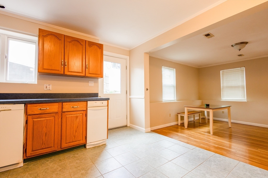 5337 B Washington Street, Unit B Boston, MA 02132 - Photo 8 of 41 a kitchen with stainless steel appliances granite countertop a refrigerator and a sink