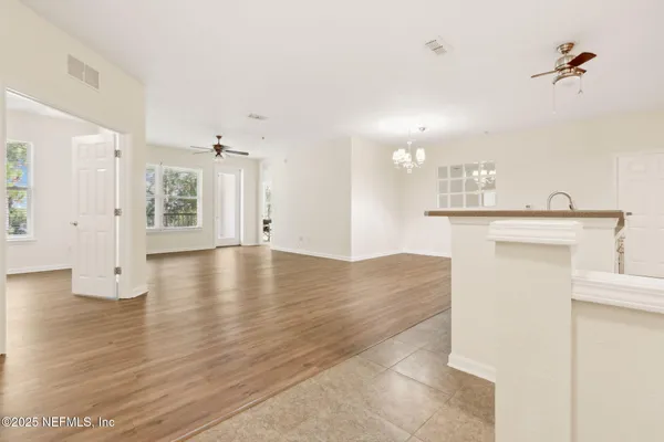 a view of empty room with wooden floor