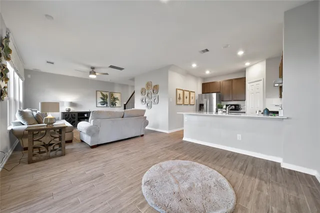 a living room with furniture and a wooden floor