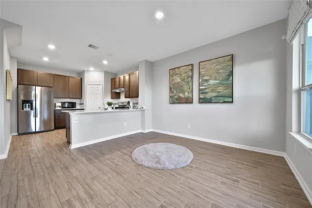 a view of kitchen with cabinets and wooden floor