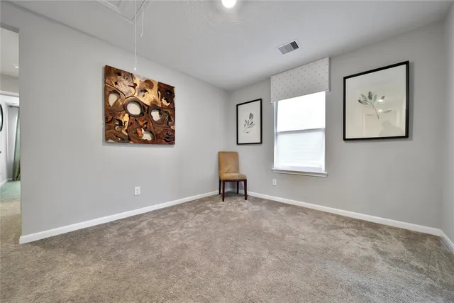 a view of workspace with painting on the wall and a window