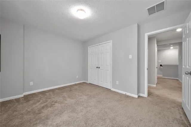 a view of an empty room and closet