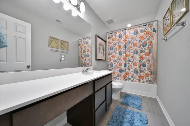 a bathroom with a sink a large mirror and a shower