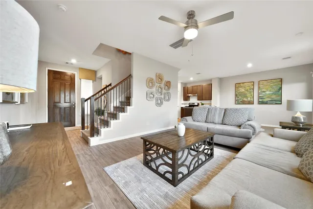 a living room with furniture or couches and a dining table with wooden floor