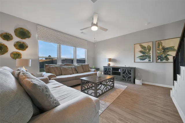 a living room with furniture and a large window