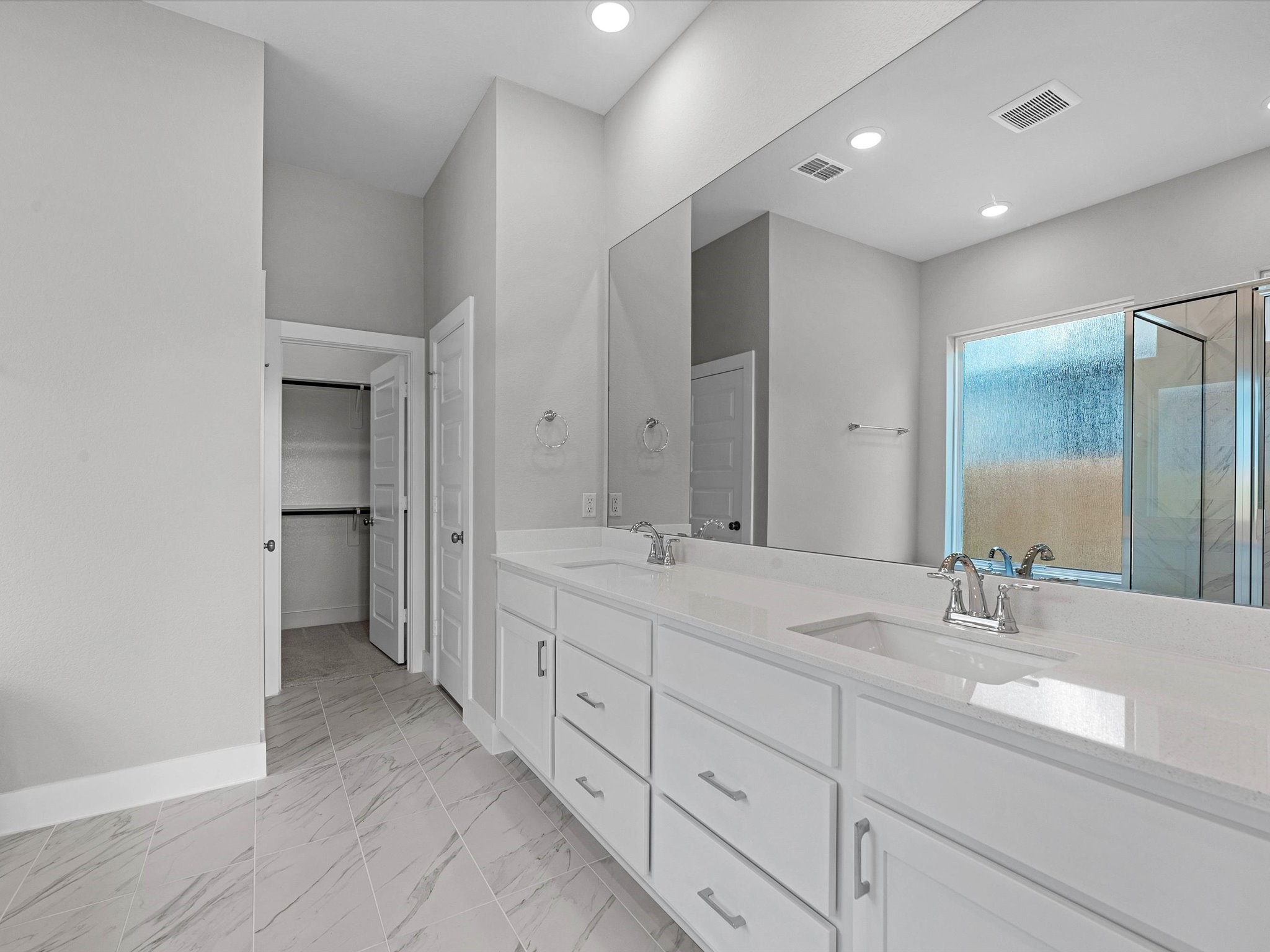 17242 Gleeful Street Hockley, TX 77447 - Photo 11 of 22 a spacious bathroom with a double vanity sink double and mirror