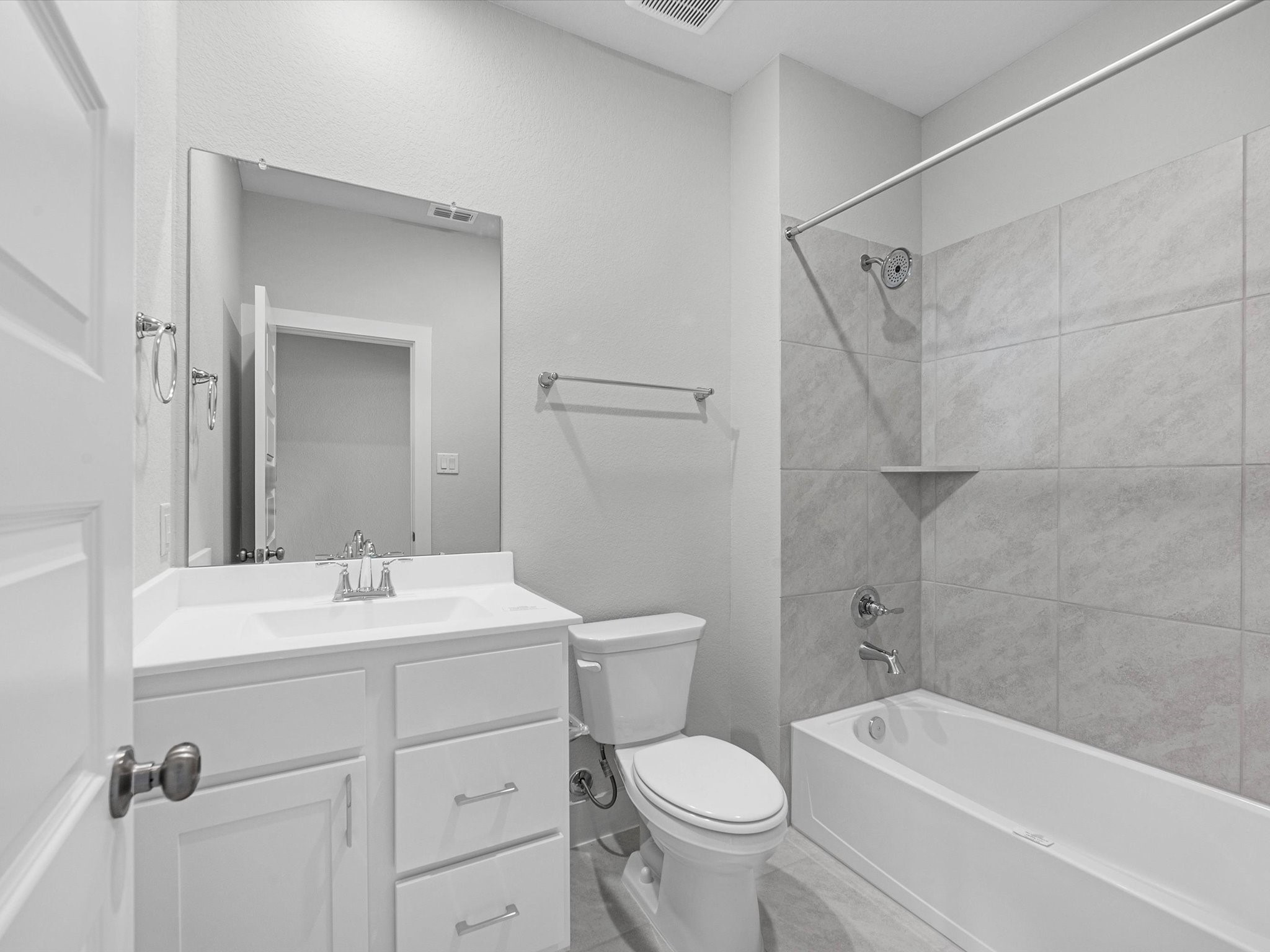 17242 Gleeful Street Hockley, TX 77447 - Photo 18 of 22 a bathroom with a toilet sink vanity tub and shower