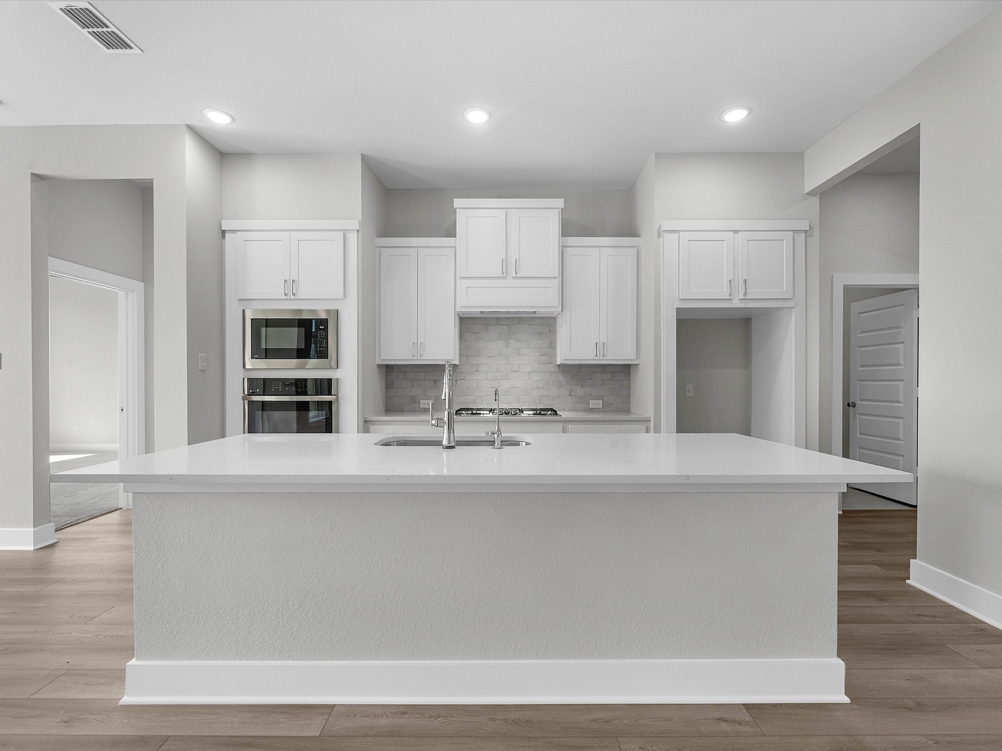 17242 Gleeful Street Hockley, TX 77447 - Photo 2 of 22 a view of a kitchen with kitchen island a sink stainless steel appliances and cabinets