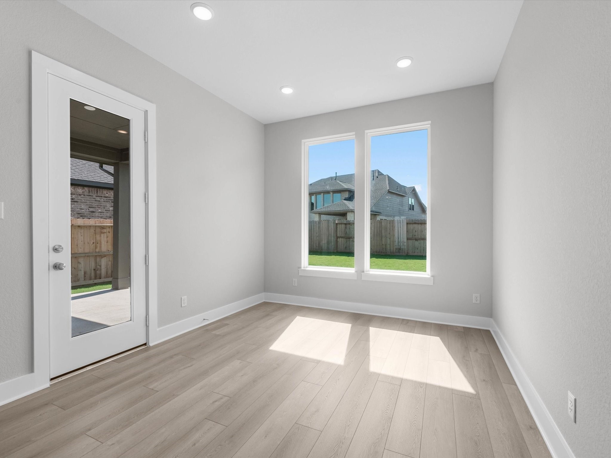 17242 Gleeful Street Hockley, TX 77447 - Photo 9 of 22 an empty room with wooden floor and windows