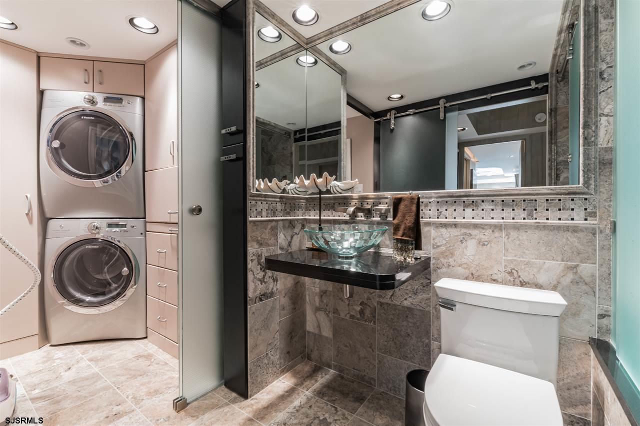 2700 Atlantic Avenue, Unit 419 Longport, NJ 08403 - Photo 16 of 32 a bathroom with a toilet sink and mirror