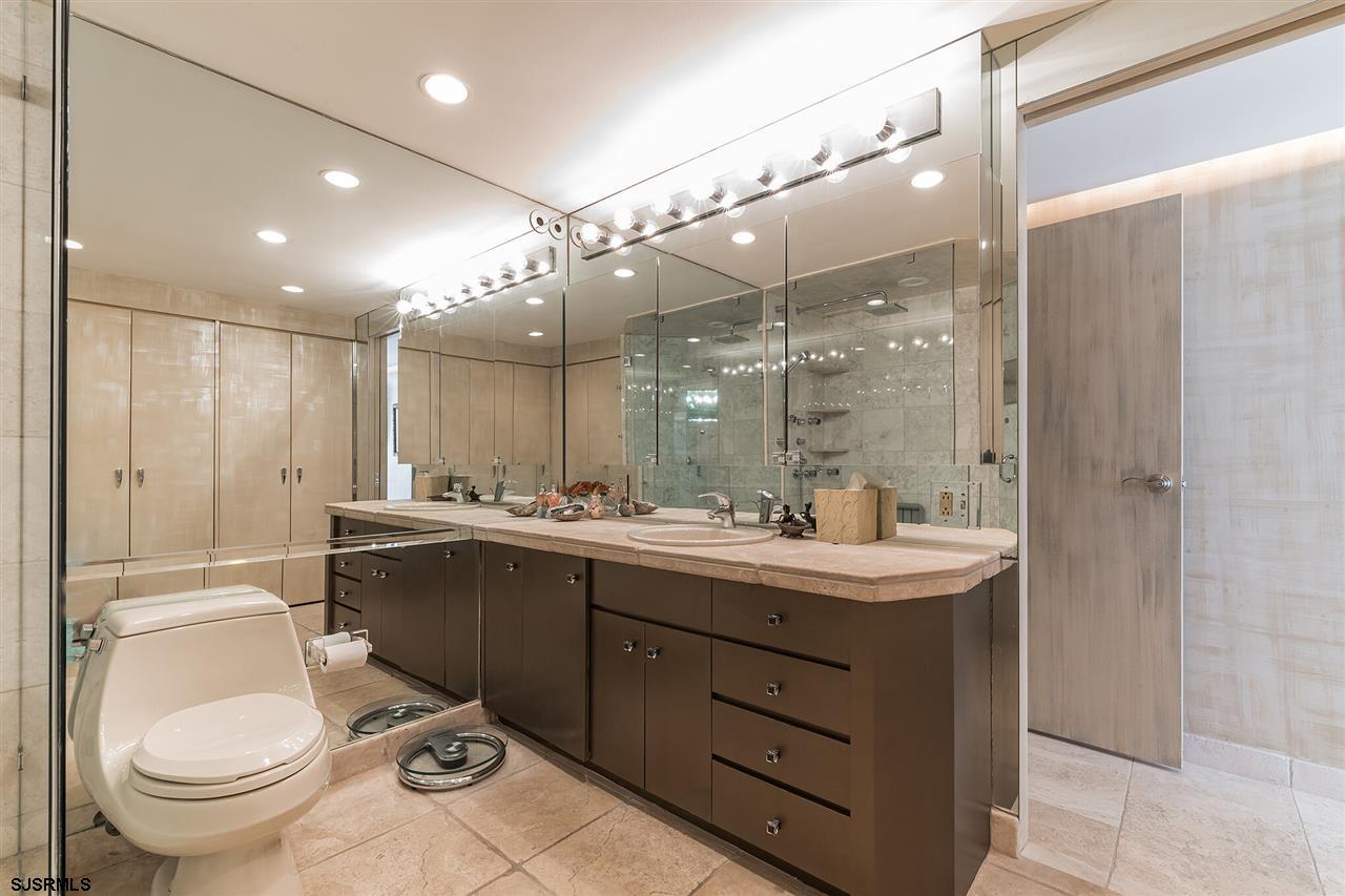 2700 Atlantic Avenue, Unit 419 Longport, NJ 08403 - Photo 20 of 32 a bathroom with a sink a toilet and mirror
