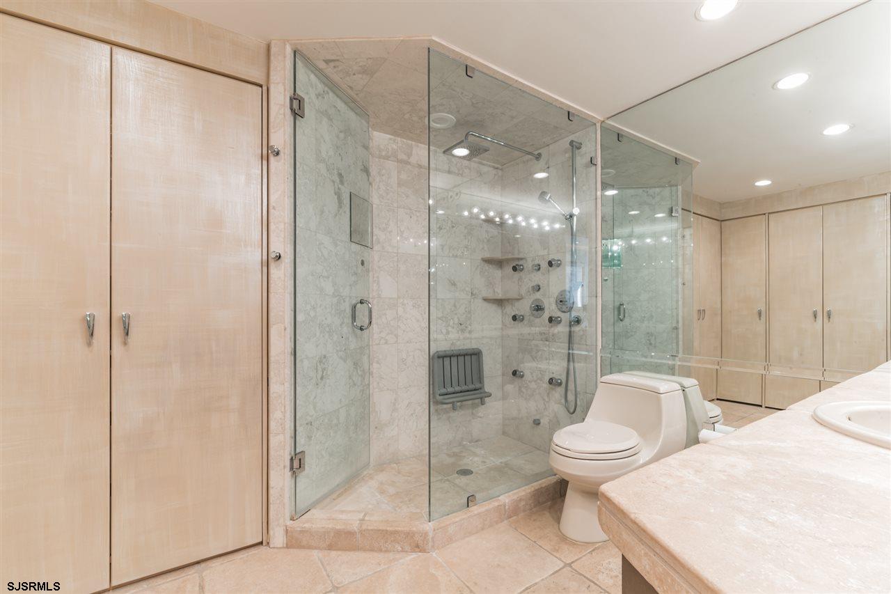 2700 Atlantic Avenue, Unit 419 Longport, NJ 08403 - Photo 21 of 32 a bathroom with a shower a toilet and a sink