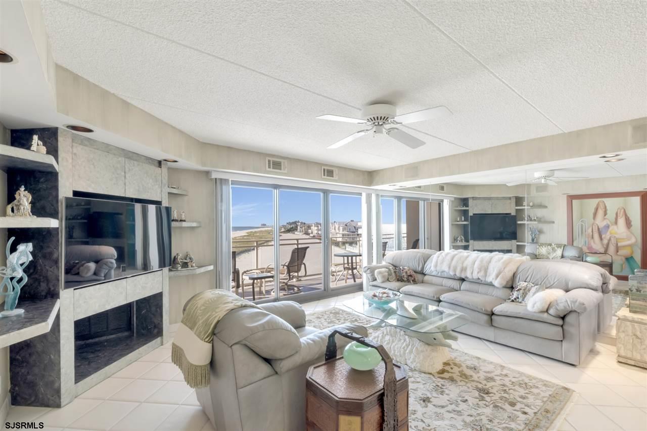 2700 Atlantic Avenue, Unit 419 Longport, NJ 08403 - Photo 5 of 32 a living room with furniture and a flat screen tv