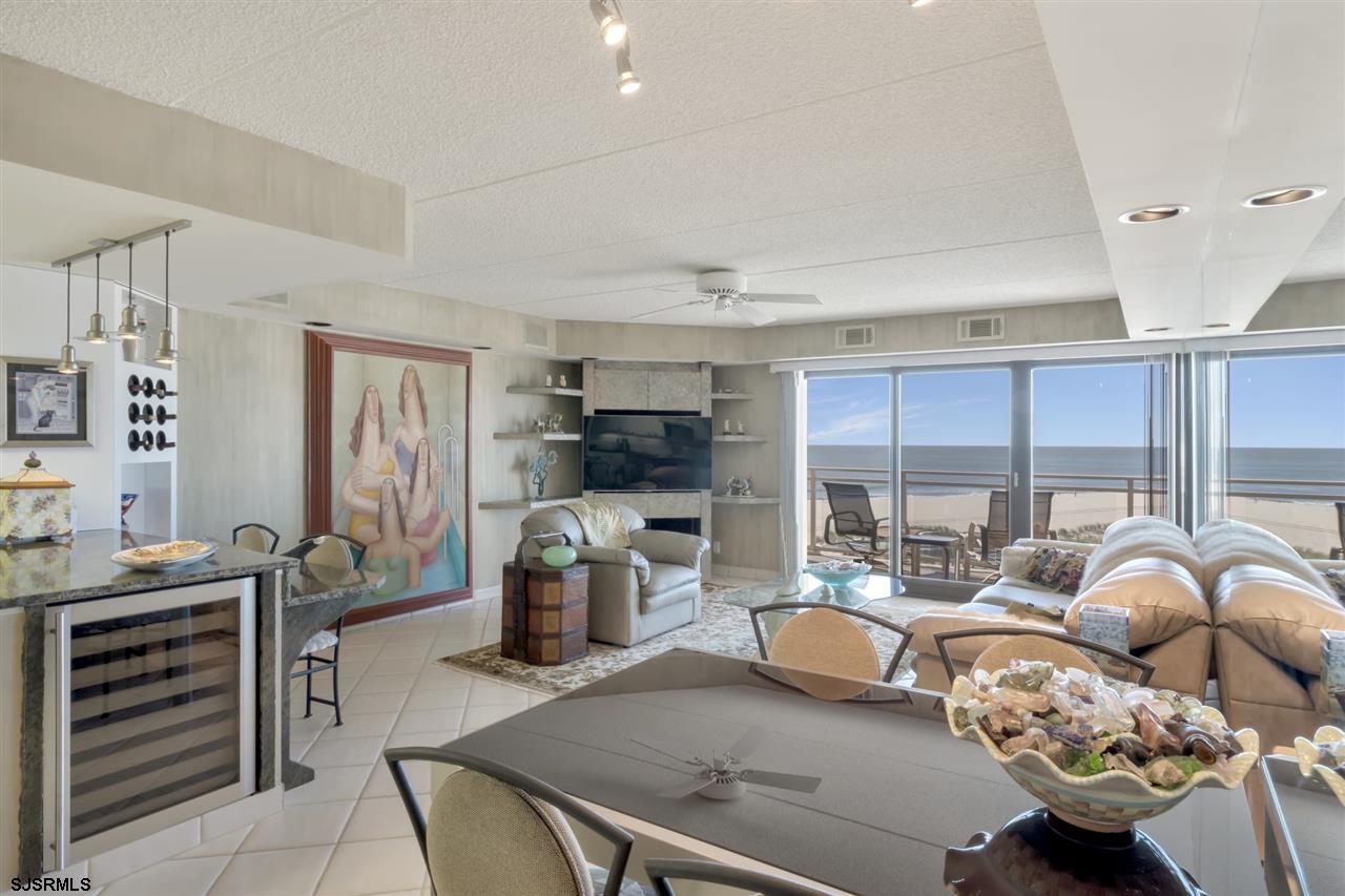 2700 Atlantic Avenue, Unit 419 Longport, NJ 08403 - Photo 6 of 32 a living room with furniture a flat screen tv and a large window