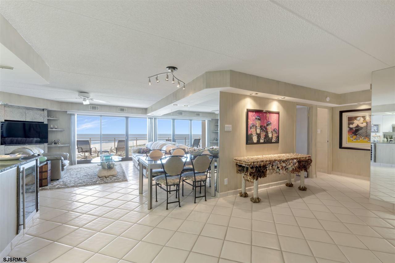 2700 Atlantic Avenue, Unit 419 Longport, NJ 08403 - Photo 7 of 32 a living room with furniture a flat screen tv and kitchen view