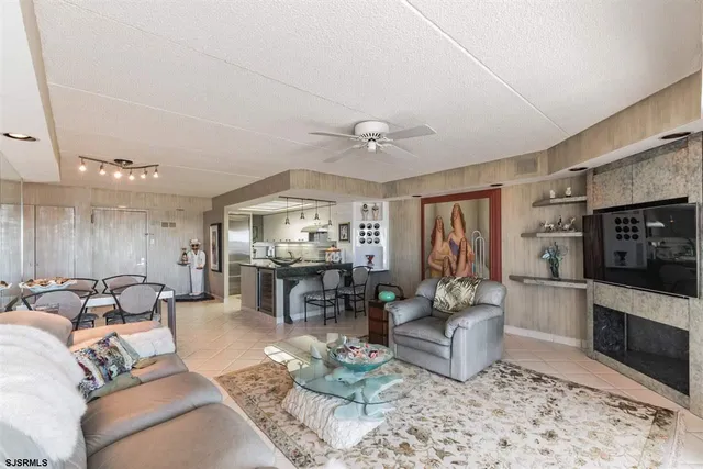 a kitchen with stainless steel appliances granite countertop a table chairs and a refrigerator