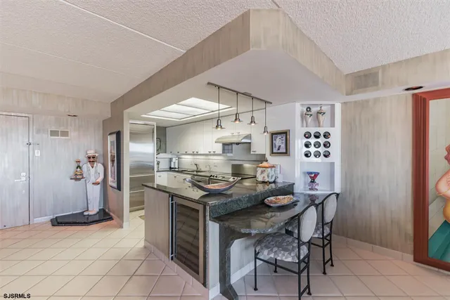 a kitchen with stainless steel appliances a stove and more cabinets