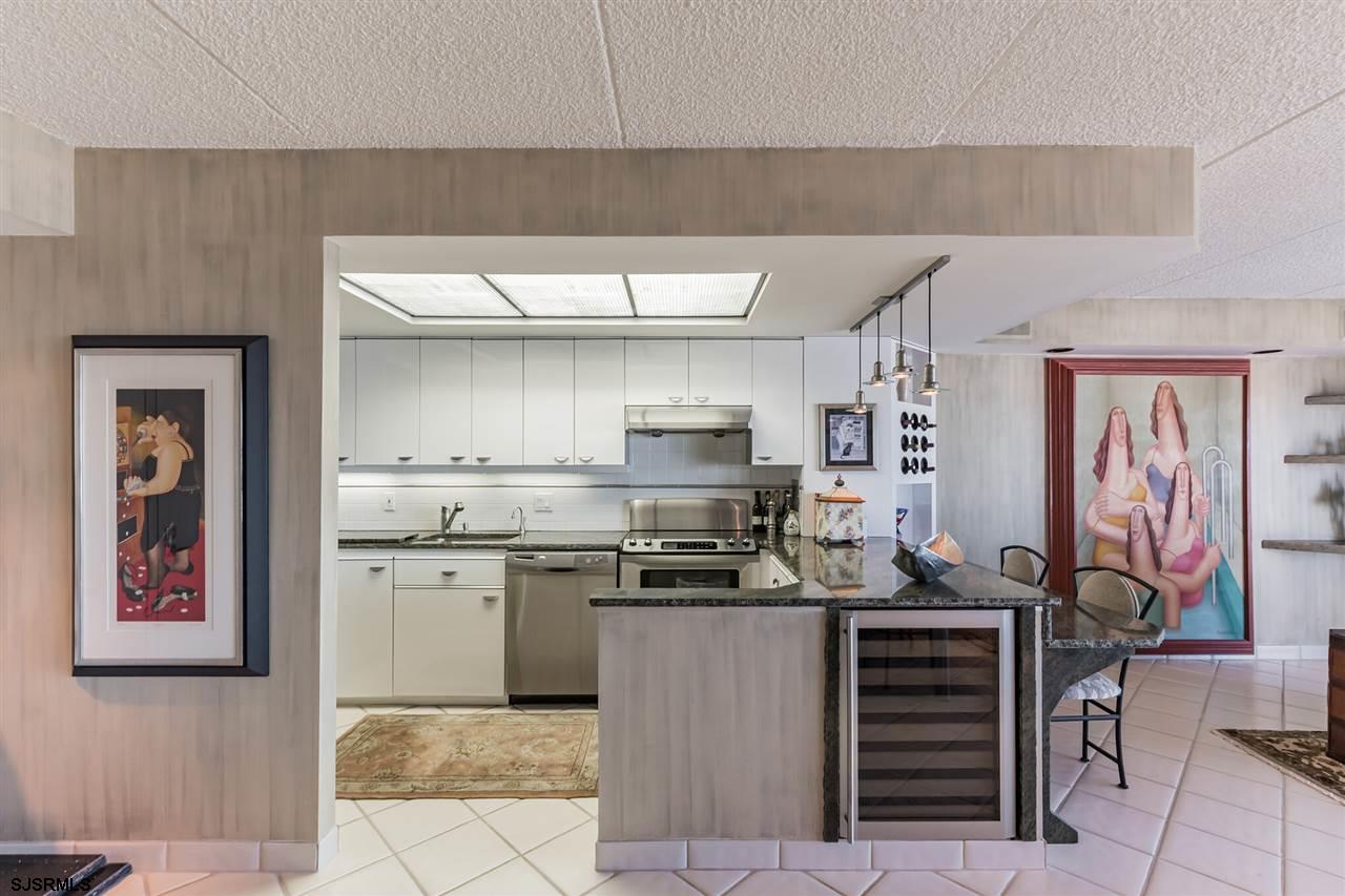 2700 Atlantic Avenue, Unit 419 Longport, NJ 08403 - Photo 10 of 32 a kitchen with stainless steel appliances a stove and more cabinets