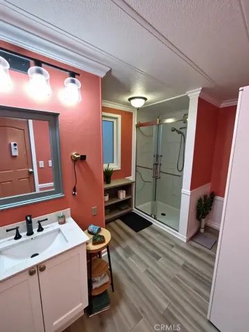 a bathroom with a sink mirror and shower