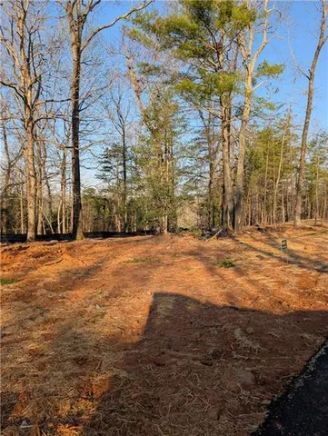 a view of dirt yard with a building
