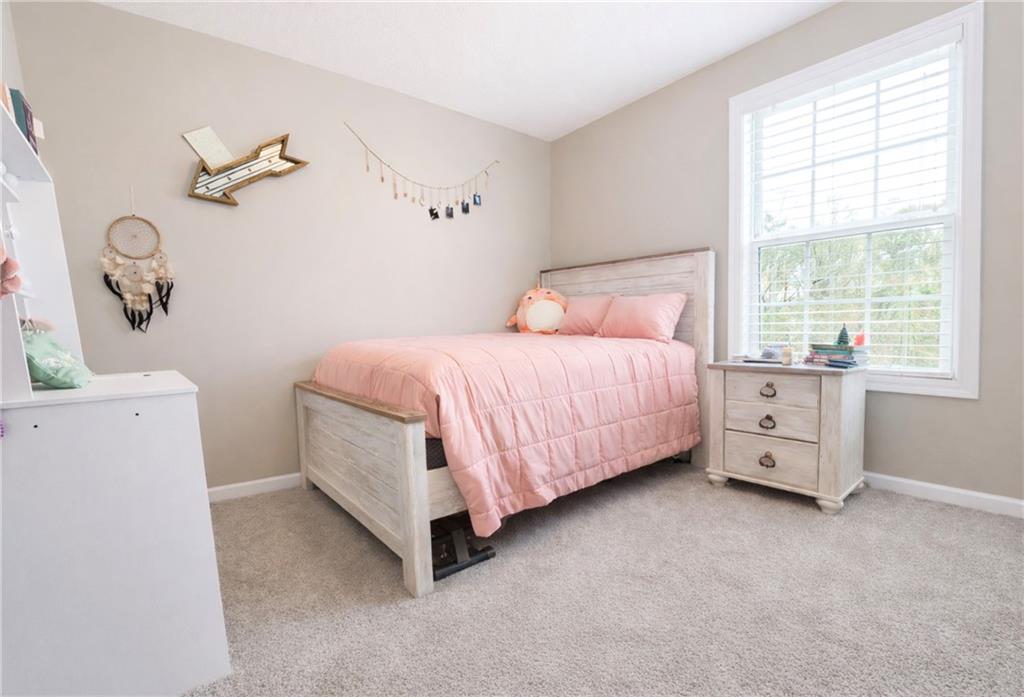 132 Sydney Summit Villa Rica, GA 30180 - Photo 14 of 20 a bedroom with a bed dresser and a window