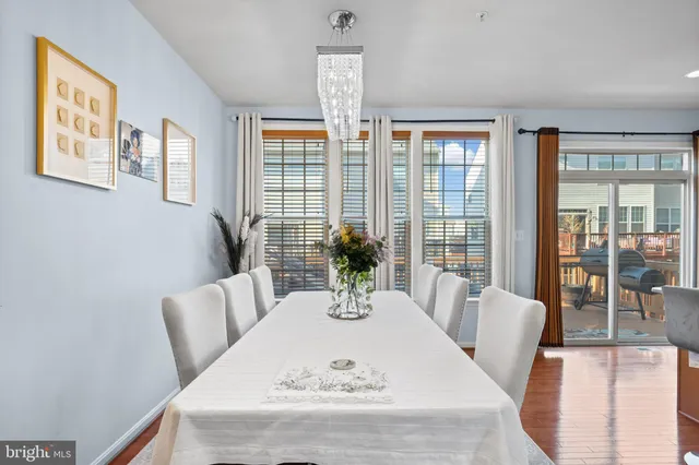 a view of a dining room with furniture wooden floor and chandelier