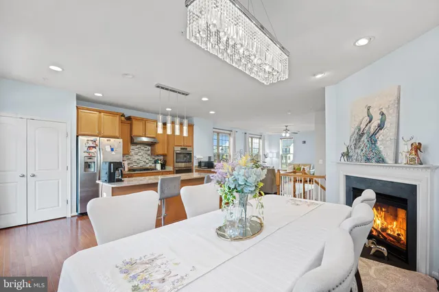 a dining room with furniture a fireplace and wooden floor
