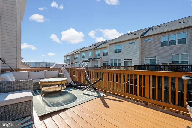 a view of a balcony with chairs and wooden floor