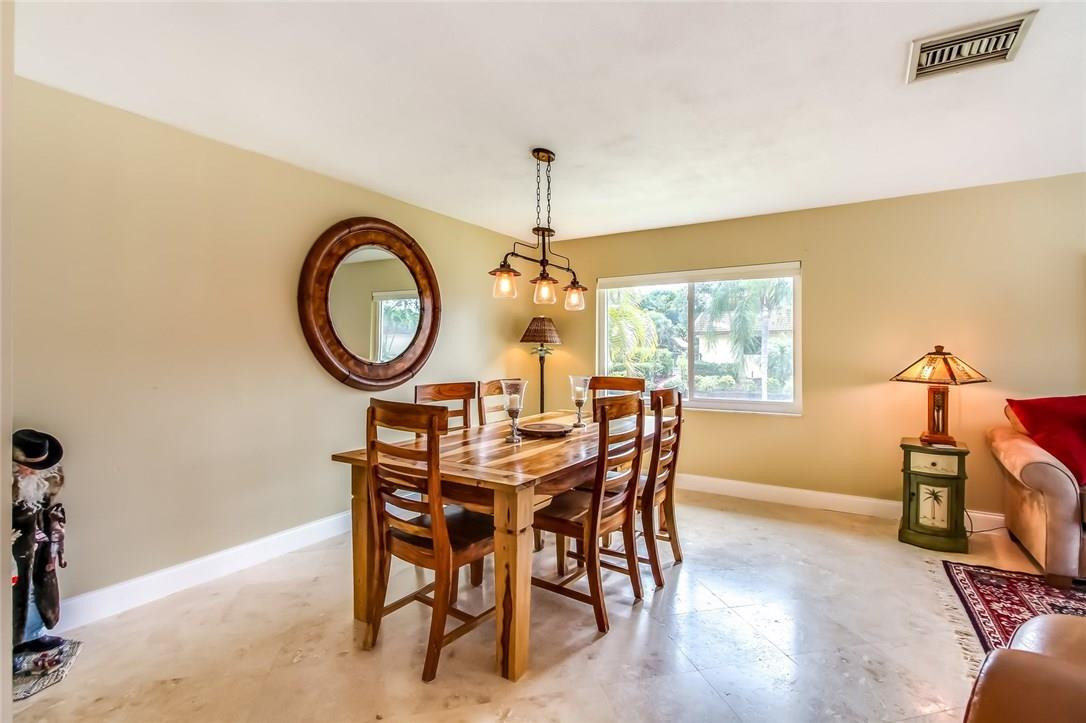 1401 Southwest 17th Street Boca Raton, FL 33486 - Photo 7 of 24 a dining room with furniture a chandelier and a rug