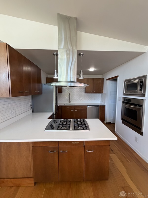 4924 Bayside Drive Riverside, OH 45431 - Photo 5 of 21 This kitchen showcases a central island, modern appliances, and rich wood cabinetry.