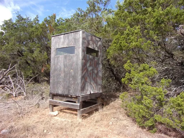 a wooden bench sitting in the middle of a forest