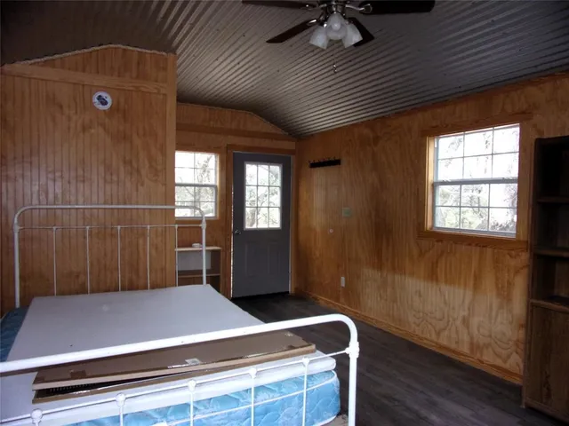 a room with pool table and windows