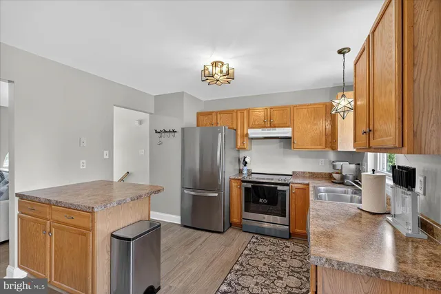 a kitchen with a refrigerator and a sink